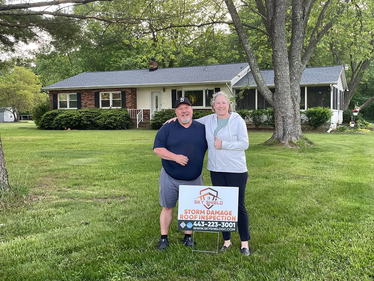 Customer with completed roof installation by Sky Shield